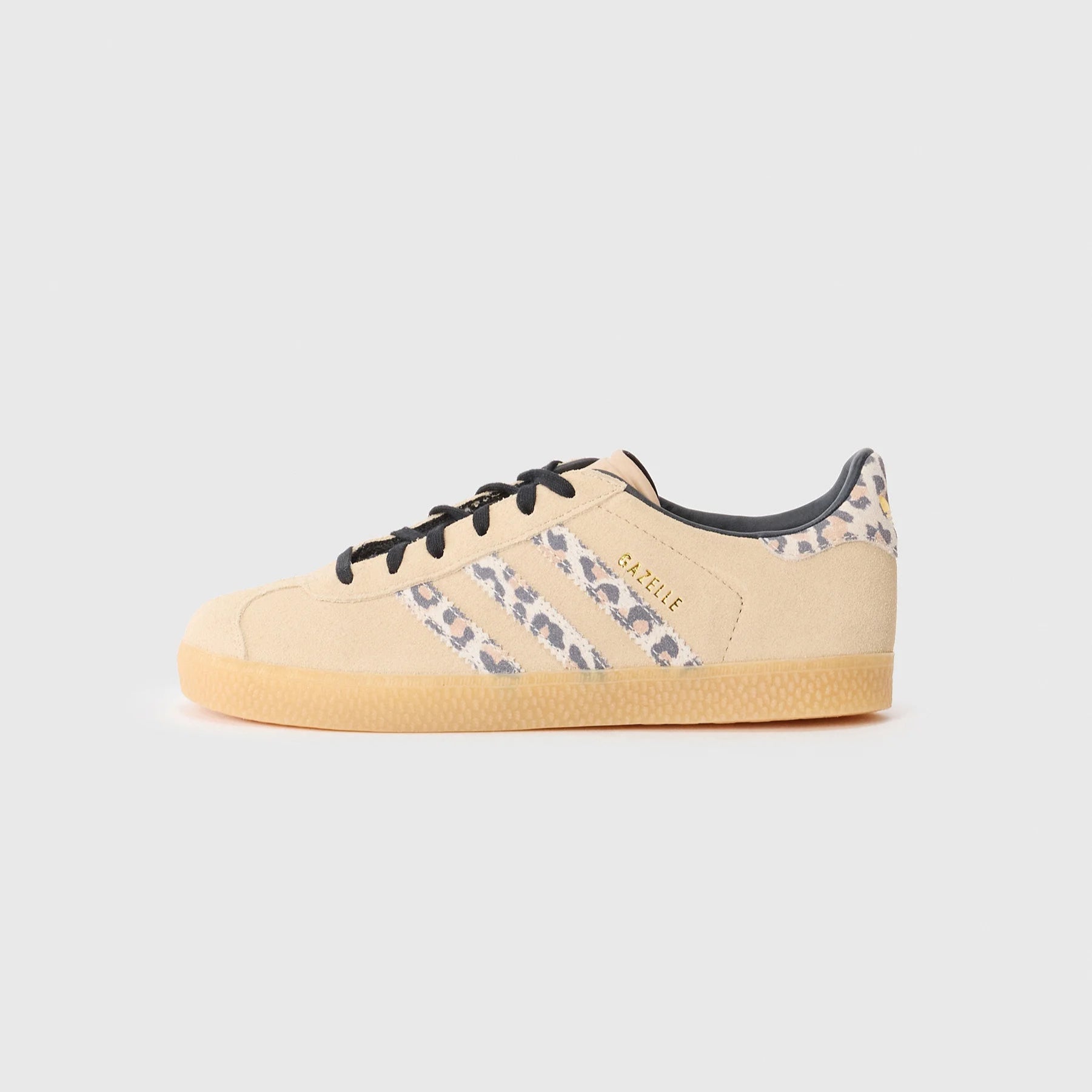 Beige sneaker with black accents on a white background