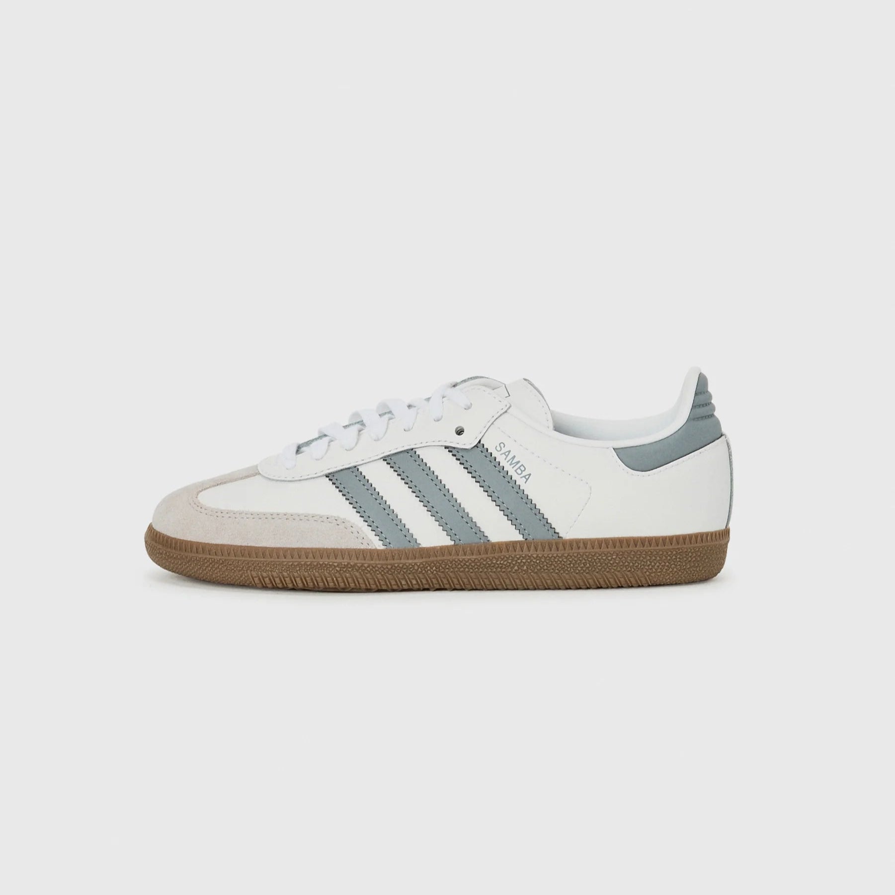 White sneaker with three gray stripes on a white background